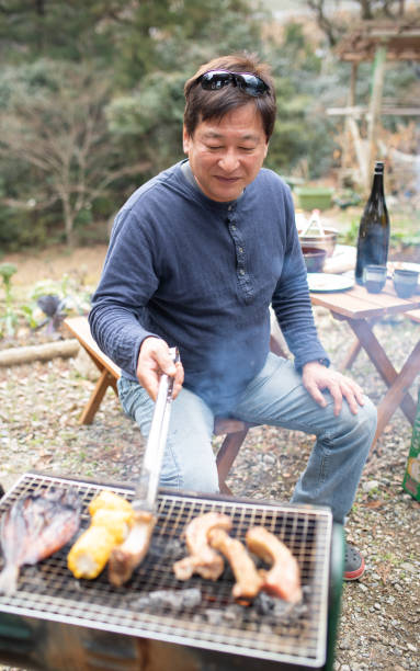 istock A man cooking on a BBQ outdoors 1302715280