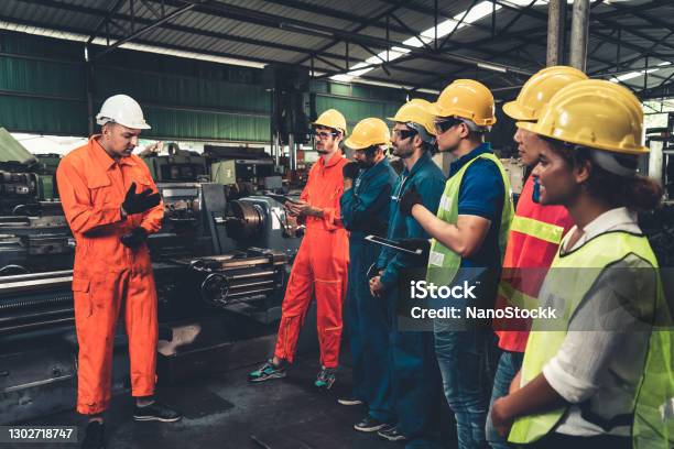 Skillful Worker Attending Brief Meeting In The Factory Stock Photo - Download Image Now