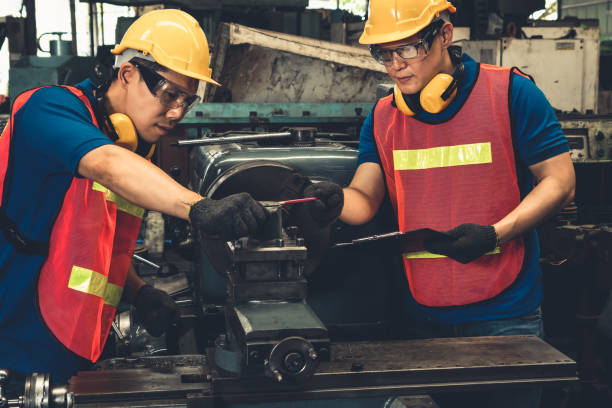 istock Group of skillful factory workers using machine equipment in workshop 1302719080