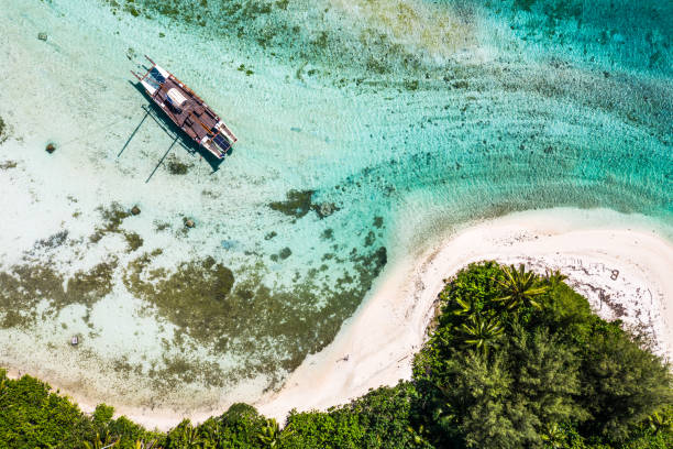 Top down view of a sailboat in the Muri lagoon in the Rarotonga in the Cooks island in Pacific stock photo