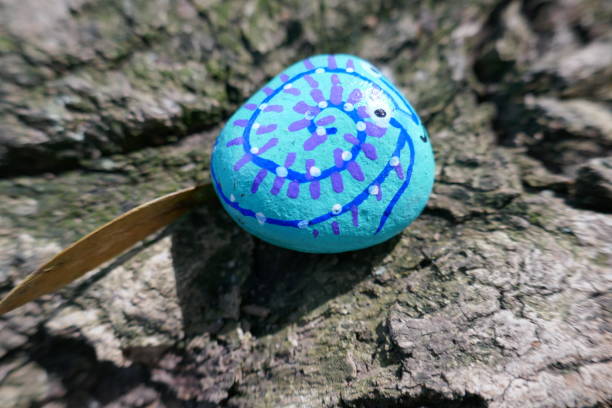 istock Kindness rock with abstract blue swirl pattern hand painted on 1302720581