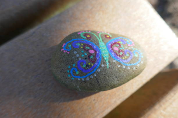 istock Kindness rock with artsy butterfly painted on 1302720669