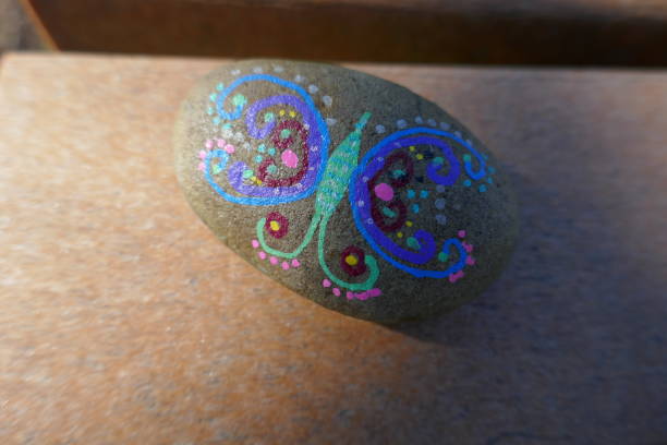 istock Kindness rock with painted artsy butterfly 1302720699