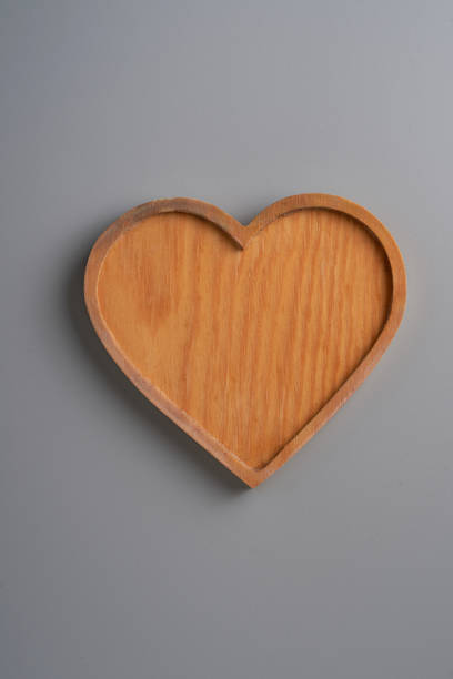 heart shape wood tray against gray background