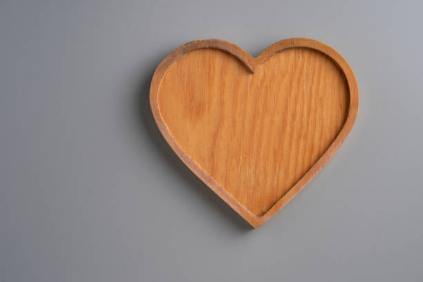 istock heart shape wood tray against gray background 1302725767