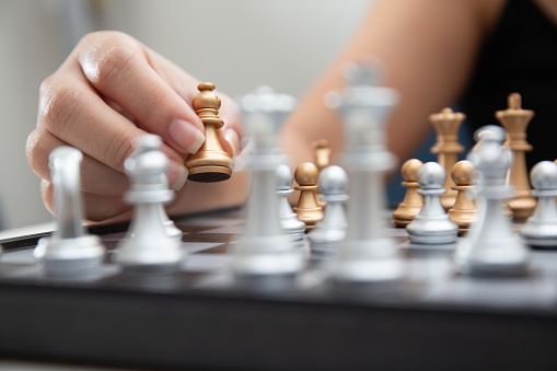 A person making a move while playing chess