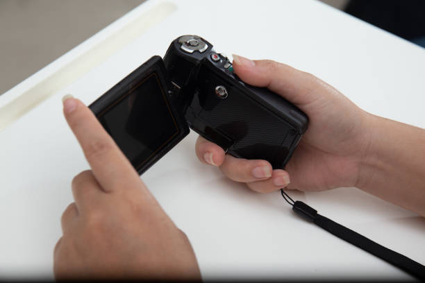istock Person checking video camcorder for footage 1302725958