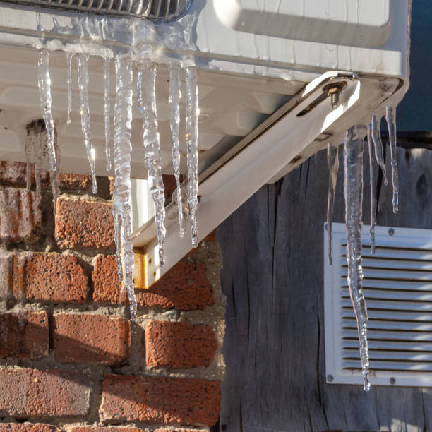 istock Very beautiful transparent icicles hanging structures of the house. Icicles falling danger concept 1302728469