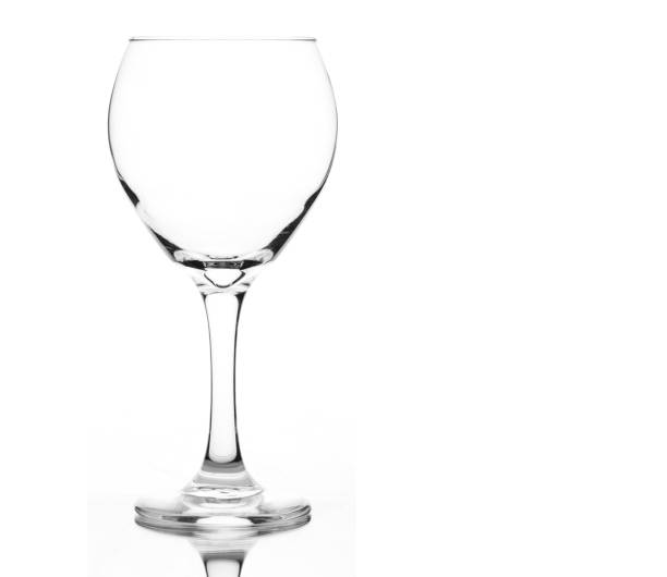 Row of empty wineglasses on well lit table. Spots and dust carefully removed. Selective focus, monochromatic.
