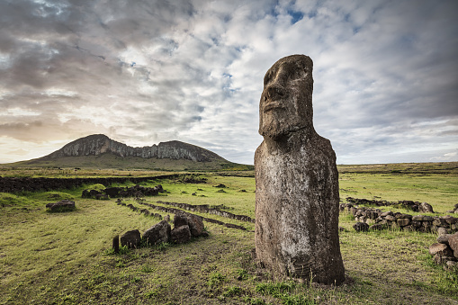 Easter Island - Rapa Nui - Ahu Tongariki, also called the Travelling Moai on green landscape under moody dramatic skyscape.  Moai Ahu Tongariki, Rapa Nui National Park, Hanga Roa, Easter Island - Isla de Pascua, Oceania, Chile