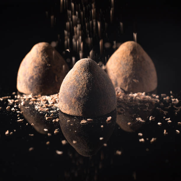 istock Chocolate candy truffles, on a black background, copy space 1302731522