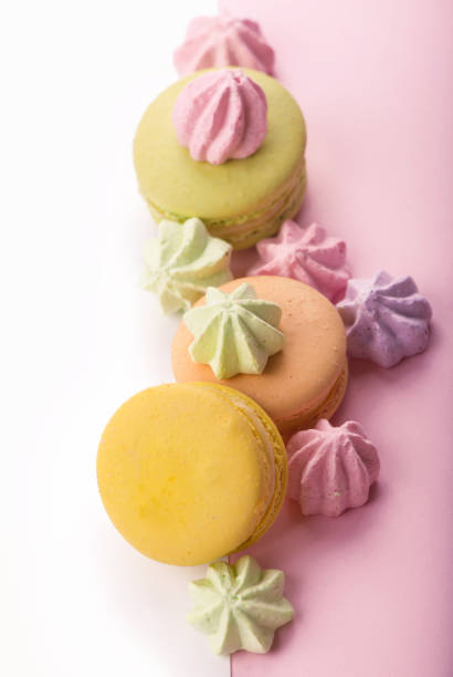 istock Dessert cake macaron or macaroon on pink background top view. Flat lay composition 1302734099