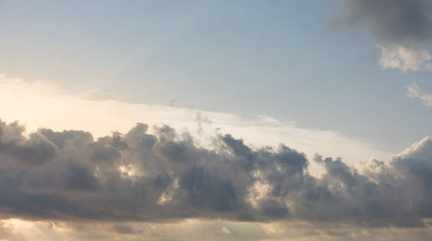 istock Beautiful blue sky with clouds and sun behind them. 1302737510