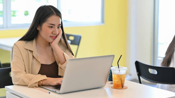 istock Businesswoman working with laptop on the table in co-working space 1302737614