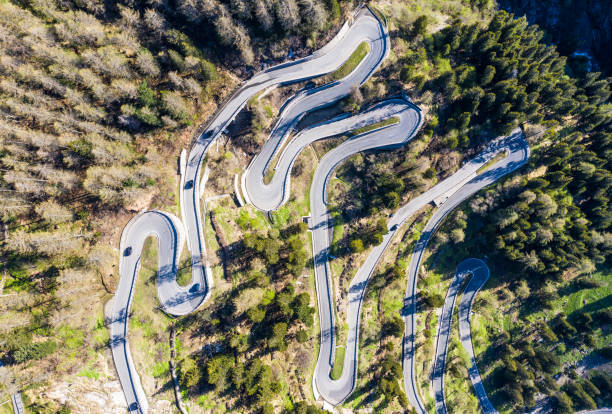 Top down view of the famous Maloja pass winding road in the alps in Canton Graubünden in Switzerland Top down view of the famous Maloja pass winding road in the alps in Canton Graubünden in Switzerland maloja region stock pictures, royalty-free photos & images