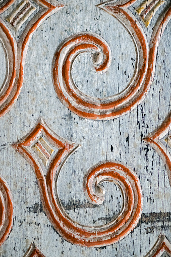 Carved and painted detail on old African wooden door