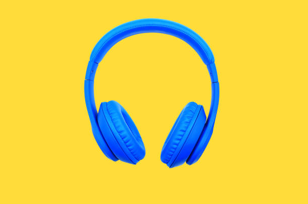istock Blue headphones isolated on yellow background. Music object concept 1302741882
