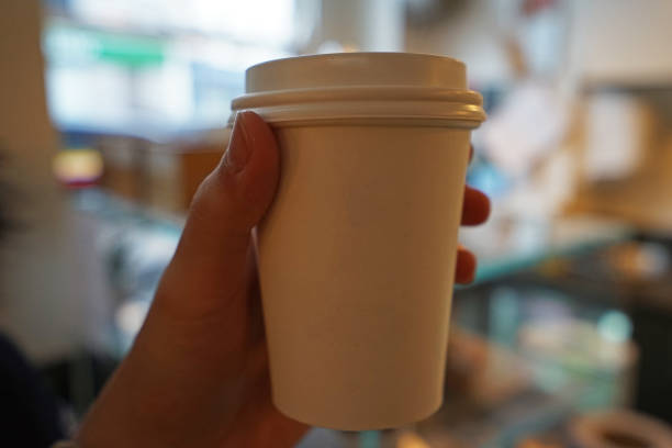 istock Hand holding hot coffee in take away cup 1302741888