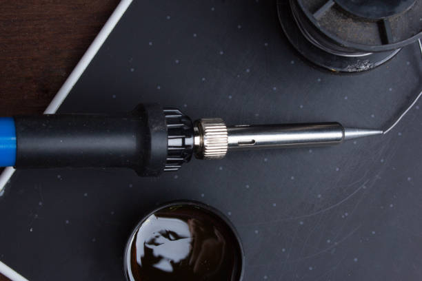 istock Soldering iron, and rosin, on a black background 1302741989