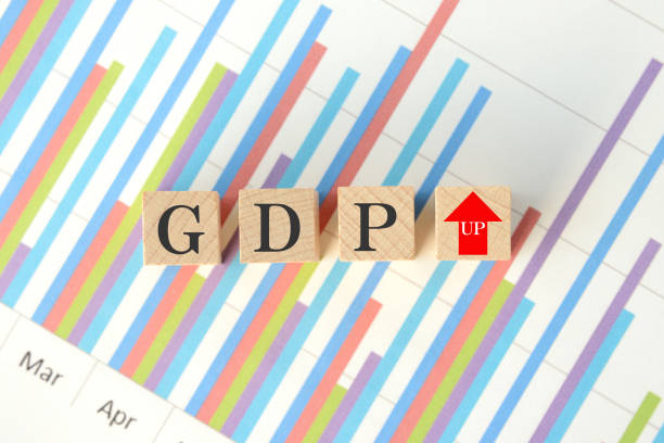 Wooden blocks with GDP words and upward arrow sign on business chart Wooden blocks with GDP words and upward arrow sign on business chart consumer confidence photos stock pictures, royalty-free photos & images
