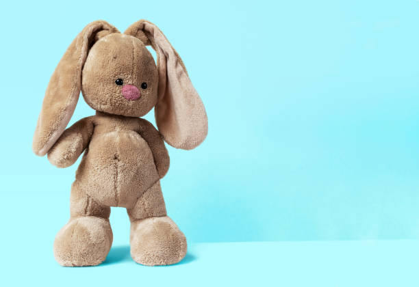 istock The soft toy bunny stays on a bright blue background 1302746179
