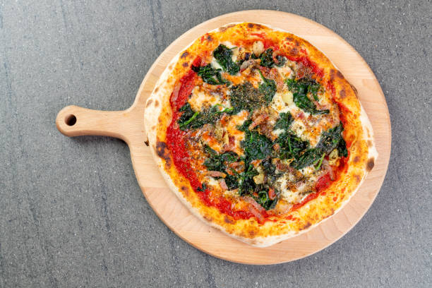 istock Baked pizza with bacon, mozzarella and spinach 1302746880