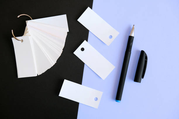 istock Two colored background  and stack of blank sheets mockup tied with a metal ring , pen, 1302747917