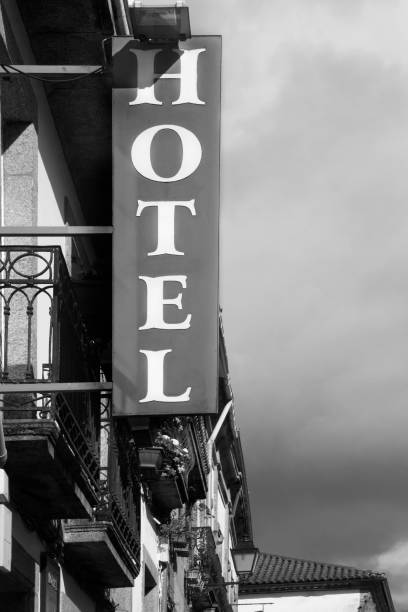 istock Hotel sign on traditional building facade. 1302748127