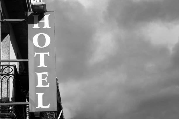 istock Hotel sign on traditional building facade. 1302748145