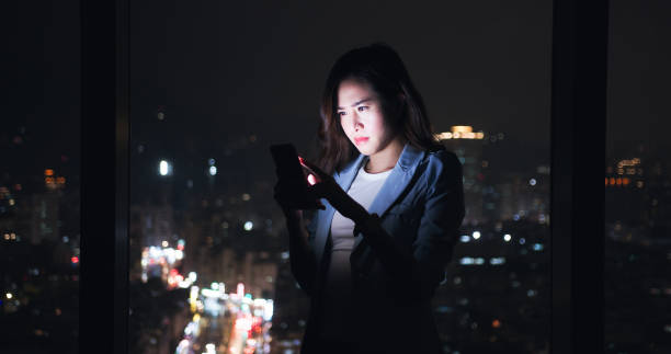 istock woman use smartphone near window 1302749451