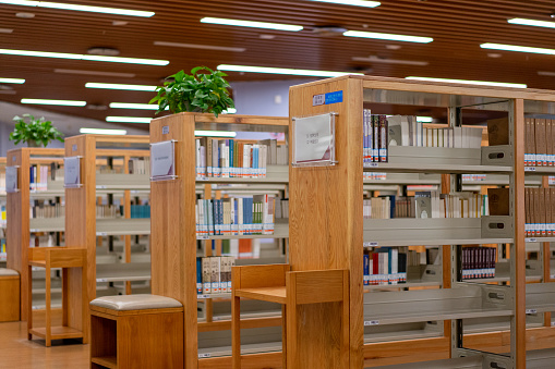 Interior of a large modern library with bookshelves.Waterloo University,Canada