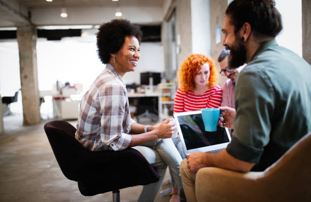 istock Business people having fun and chatting at workplace office 1302753995