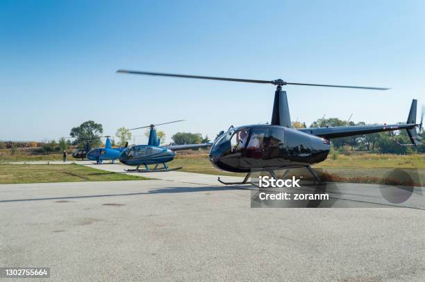 Helicopters Landed In A Row On Helipad Stock Photo - Download Image Now - Helicopter, Helicopter Pilot, Helipad