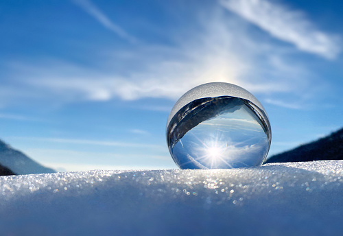 Crystal ball on the snow in the mountains.