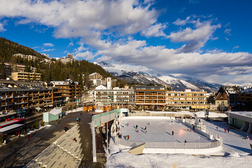 People enjoy ice skating in the heart of the Crans Montana village in Canton Valais in winter in of the of most famous ski resort of the Swiss alps