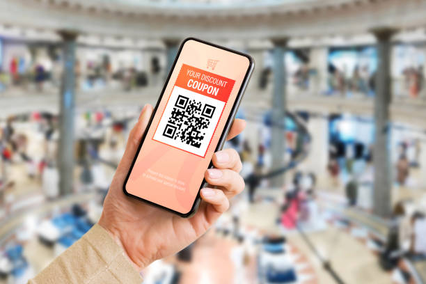 istock Person using discount coupon on mobile phone at department store 1302760623