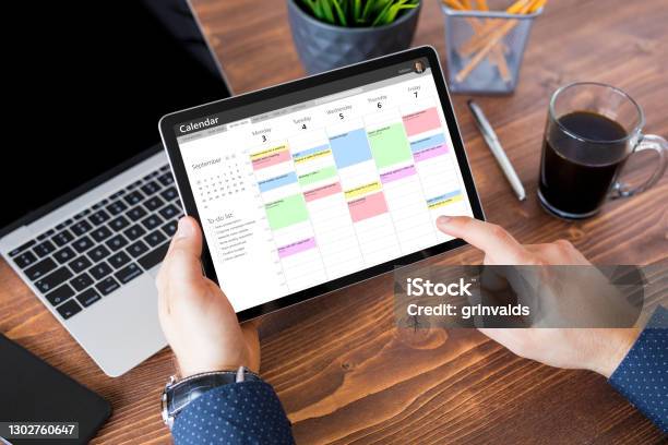 Man Using Calendar App On Tablet At Work Stock Photo - Download Image Now - Calendar, Personal Organizer, Digital Tablet