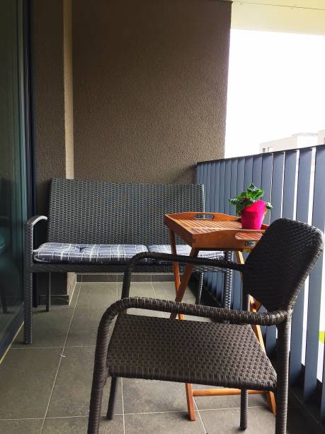 istock an armchair, a sofa with pillows and a table on the balcony. 1302761648