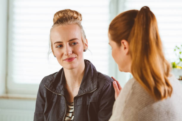 istock Therapist consoling woman during therapy session 1302761740