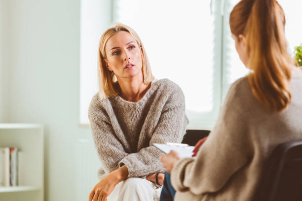 istock Woman discussing with psychotherapist 1302762078