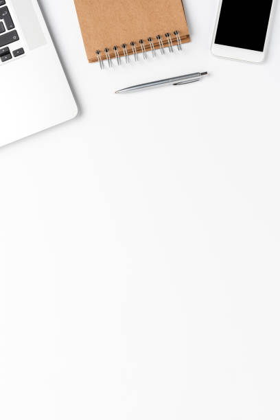 istock Business background with laptop, mobile phone, notebook and pen. Office desktop. Top view 1302763253