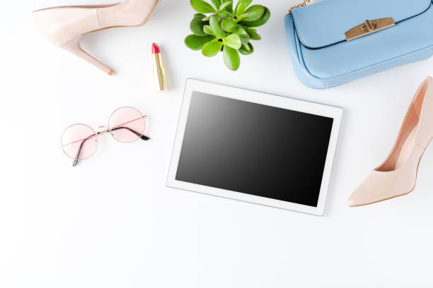 istock Empty digital tablet with women's clothes. Online shopping 1302763439