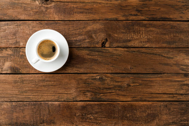istock Coffee cup on vintage wooden table with copyspace. Top view 1302764058