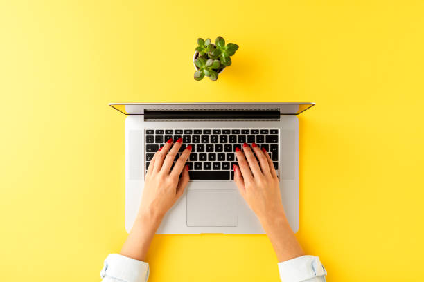 istock Elegant office desktop with female hands working on laptop. Business workspace 1302764252