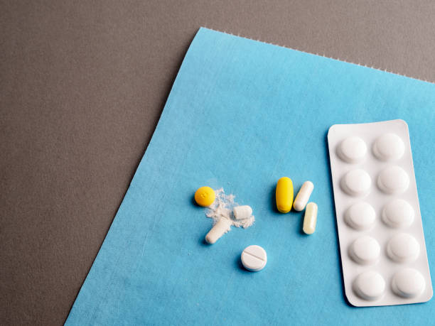 istock Many pills and tablets on gray - blue background 1302765772