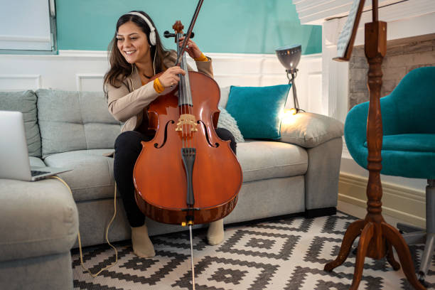 istock Smiling woman playing cello 1302766549