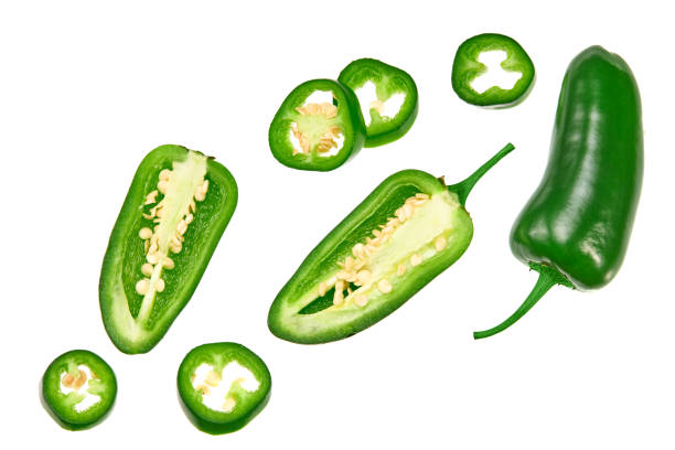 sliced jalapeno peppers isolated on white background. green chili pepper. capsicum annuum. top view - chopped imagens e fotografias de stock