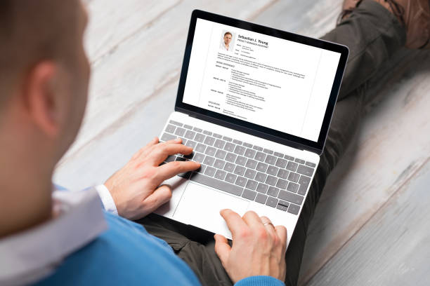 istock Man creating his CV on laptop. All contents in document are made up. 1302772329