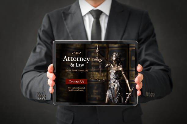 istock Man showing website of attorney on tablet 1302772448