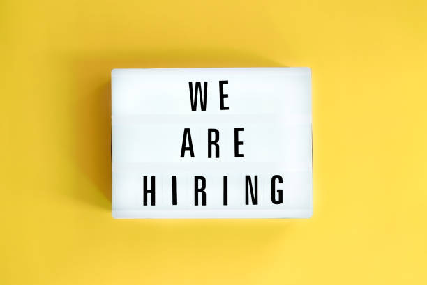 Lightbox with a words text We Are Hiring board on yellow background